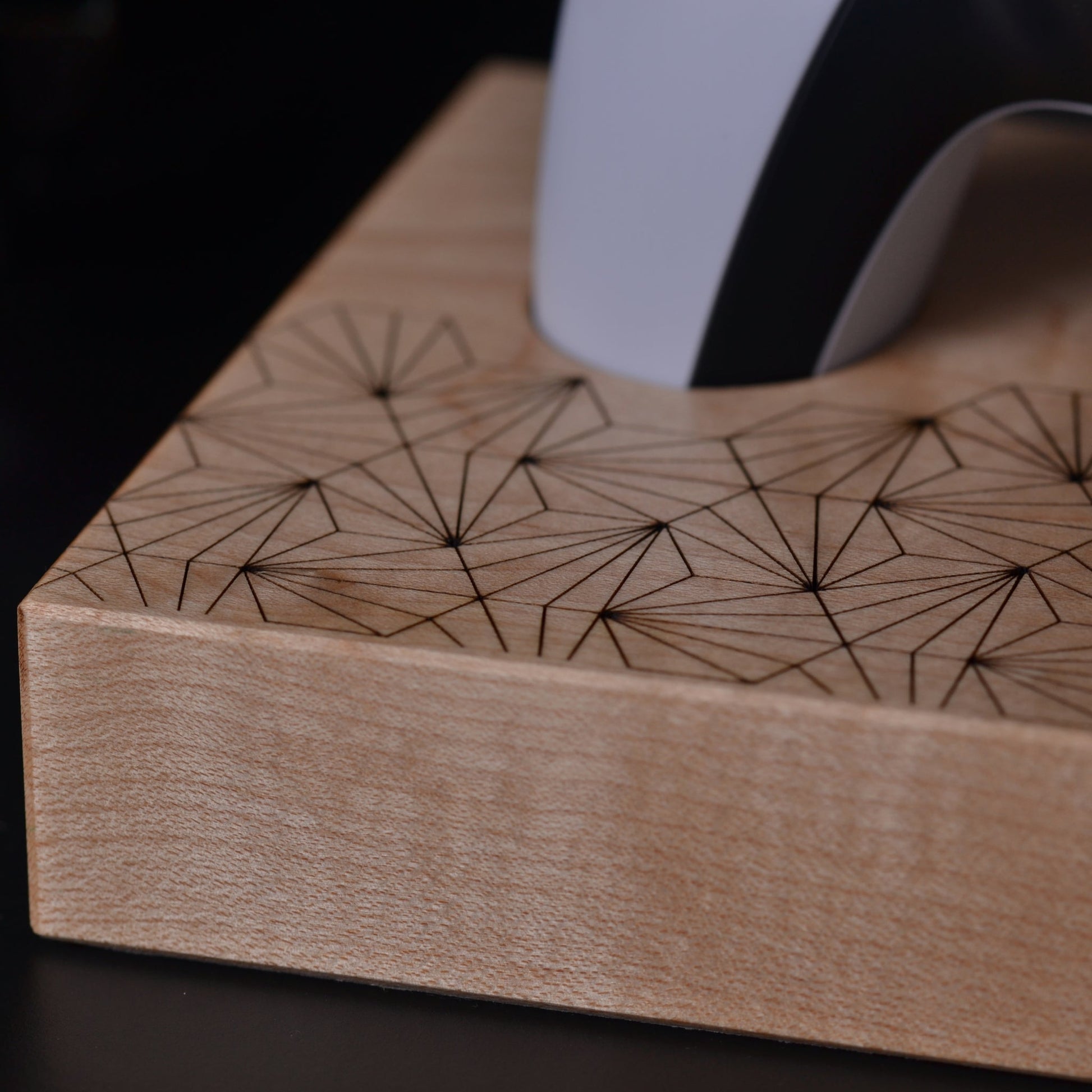 Close up detail shot of wooden stand with geometric pattern for Playstation 5 dualsense controller